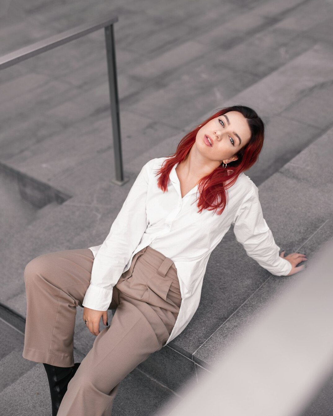 Young professional woman with red-brown hair in a light blouse